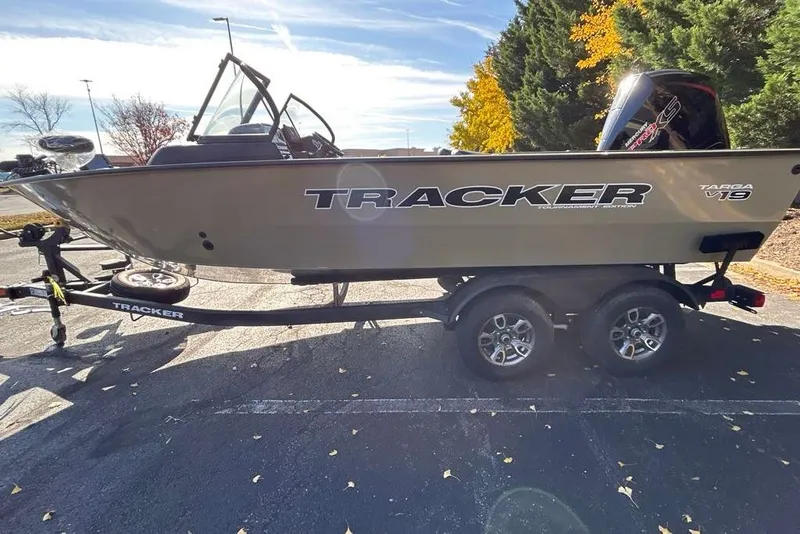 Slide: The Image of 2026 Tracker Targa V-19 Combo boat on trailer, parked outdoors with autumn trees. - 6