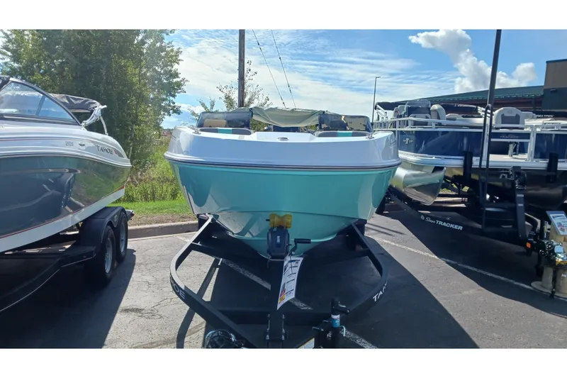 Slide: The Image of 2026 Tahoe T21 boat on trailer, displayed outdoors under a clear sky. - 3