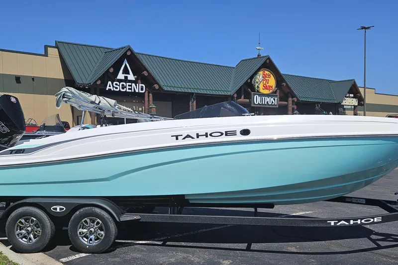Slide: The Image of 2026 Tahoe T21 boat displayed outside a store, featuring a sleek design and vibrant color. - 85