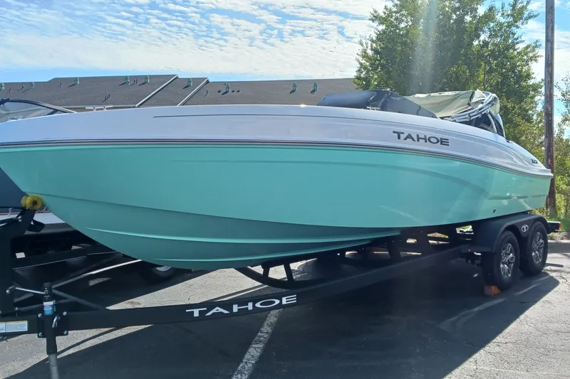 Slide: The Image of 2026 Tahoe T21 boat on trailer, parked outdoors under a clear sky. - 1