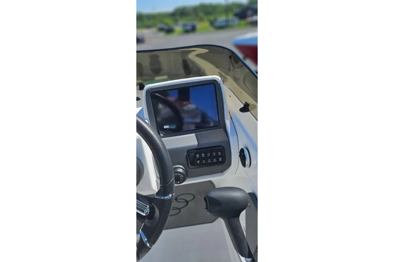 Slide: The Image of 2026 Tahoe T21 boat dashboard with steering wheel and control panel. - 90