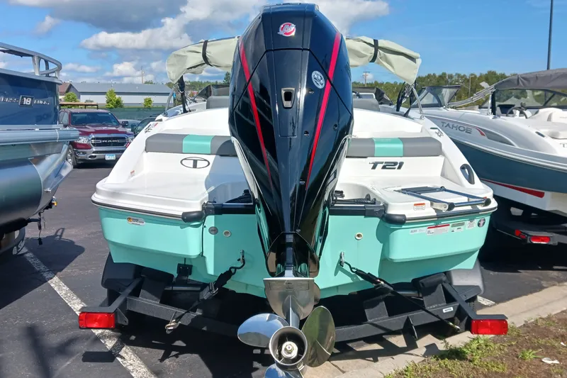 Slide: The Image of 2026 Tahoe T21 boat with outboard motor in a parking lot. - 4