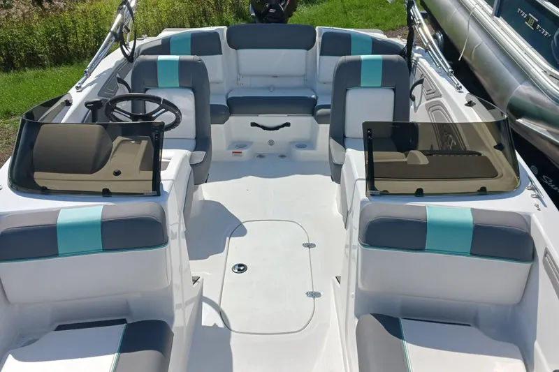 Slide: The Image of 2026 Tahoe T21 boat interior with modern seating and dual consoles, featuring teal accents. - 6