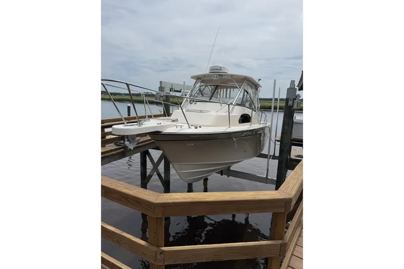 The Image of 2015 Grady-White Marlin 300 boat on trailer, parked outdoors. - 1