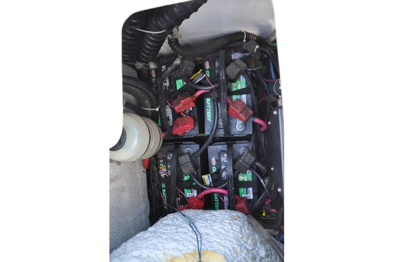 Slide: The Image of Battery compartment of 2015 Grady-White Marlin 300 boat, showing multiple batteries and wiring. - 13