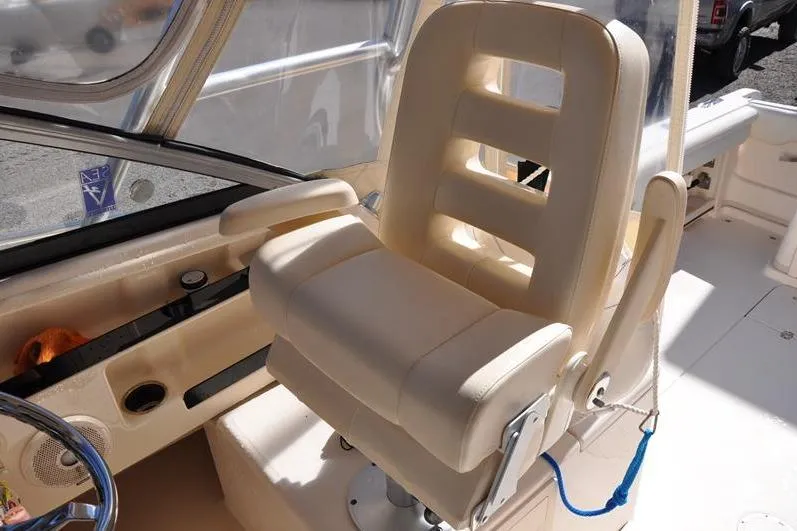 Slide: The Image of Captain's chair on 2015 Grady-White Marlin 300 boat, featuring beige upholstery. - 15