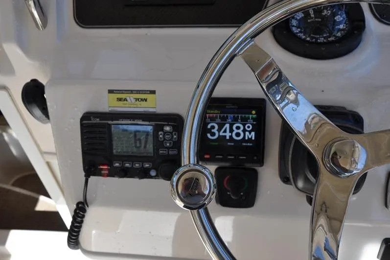 Slide: The Image of Steering wheel and dashboard of 2015 Grady-White Marlin 300 boat with navigation instruments. - 19