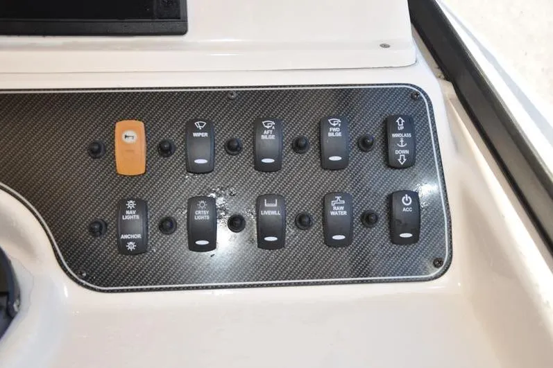Slide: The Image of Control panel of a 2015 Grady-White Marlin 300 boat with labeled switches. - 23
