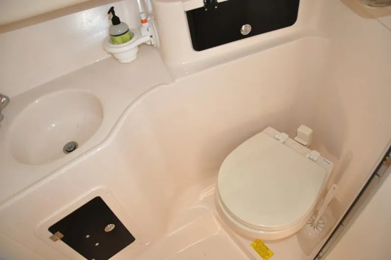 Slide: The Image of 2015 Grady-White Marlin 300 boat bathroom with sink and toilet. - 27