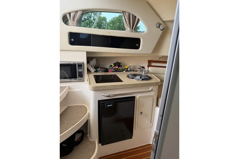 Slide: The Image of 2015 Grady-White Marlin 300 boat on trailer, parked outdoors near a building. - 4