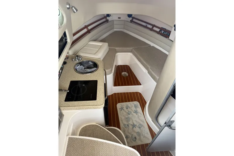 Slide: The Image of 2015 Grady-White Marlin 300 boat on trailer outside a garage. - 5