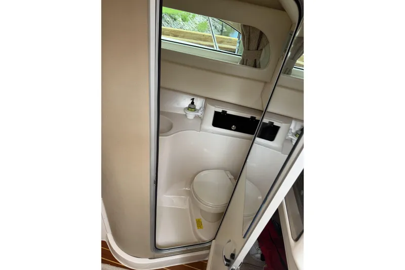 Slide: The Image of 2015 Grady-White Marlin 300 boat on trailer, parked outdoors near a building. - 6