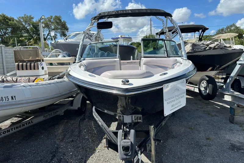 Slide: The Image of 2007 MasterCraft X-15 boat on trailer, displayed outdoors under a clear blue sky. - 1