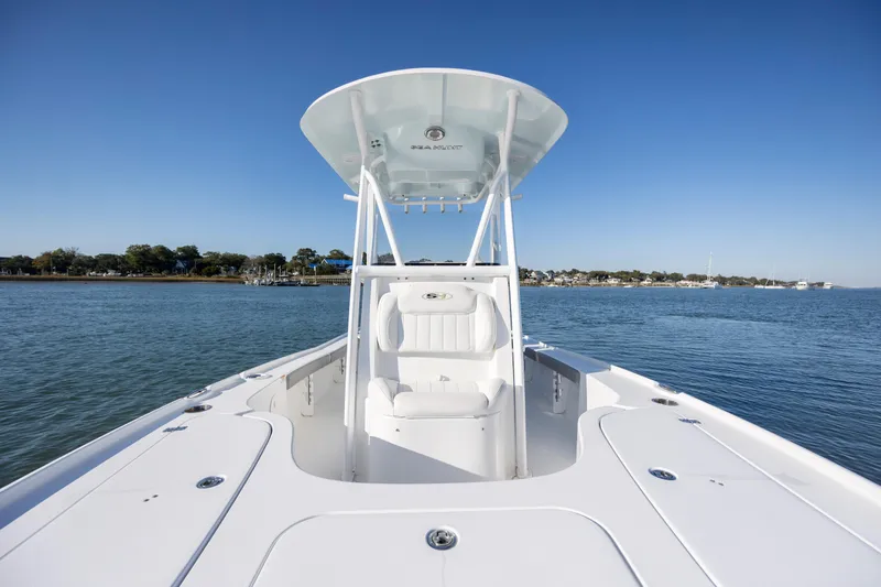 Slide: The Image of 2019 Sea Hunt BX 22 BR boat on calm water, clear sky background. - 13