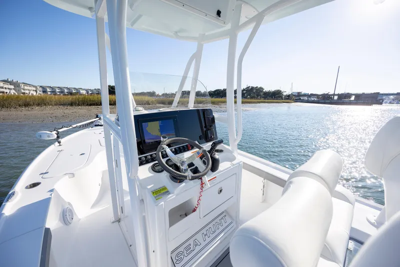 Slide: The Image of 2019 Sea Hunt BX 22 BR boat on water, featuring modern dashboard and steering wheel. - 17