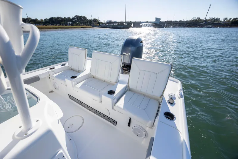 Slide: The Image of 2019 Sea Hunt BX 22 BR boat with white seating and powerful outboard motor on water. - 20