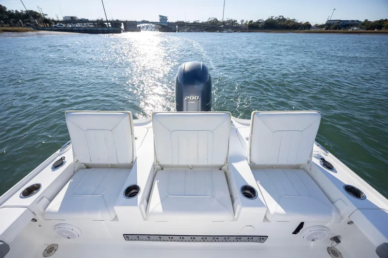 Slide: The Image of 2019 Sea Hunt BX 22 BR boat with three rear seats and outboard motor on water. - 21