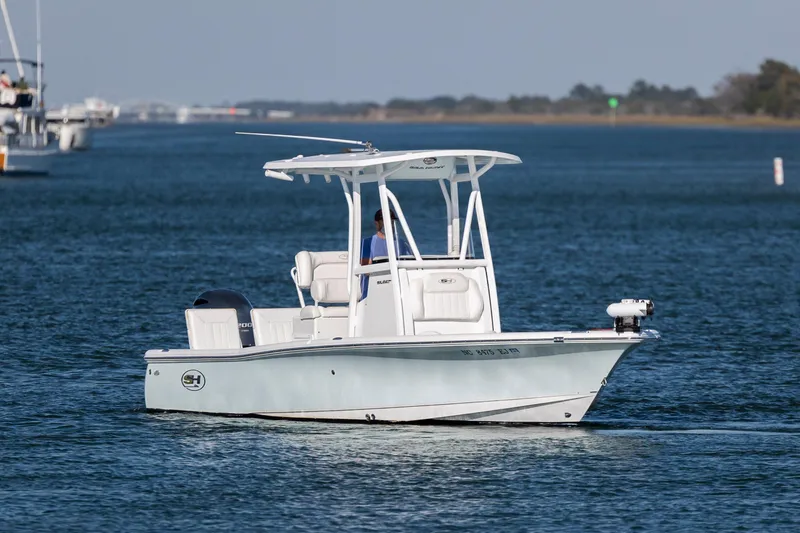 Slide: The Image of 2019 Sea Hunt BX 22 BR boat cruising on calm blue waters. - 7