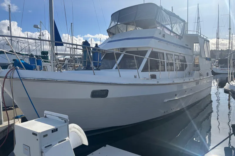 Slide: The Image of 1986 Ponderosa yacht docked at marina under clear sky. - 1
