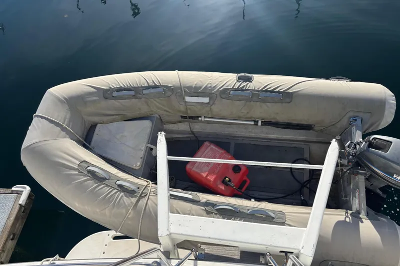Slide: The Image of Inflatable boat docked on water, featuring a red fuel container, 1986 Ponderosa. - 16