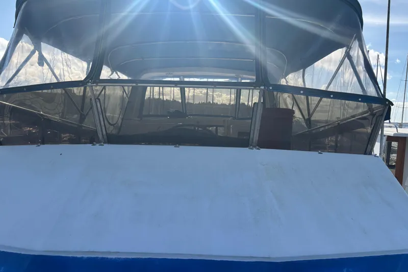 Slide: The Image of 1986 Ponderosa boat with clear canopy under bright sunlight. - 2