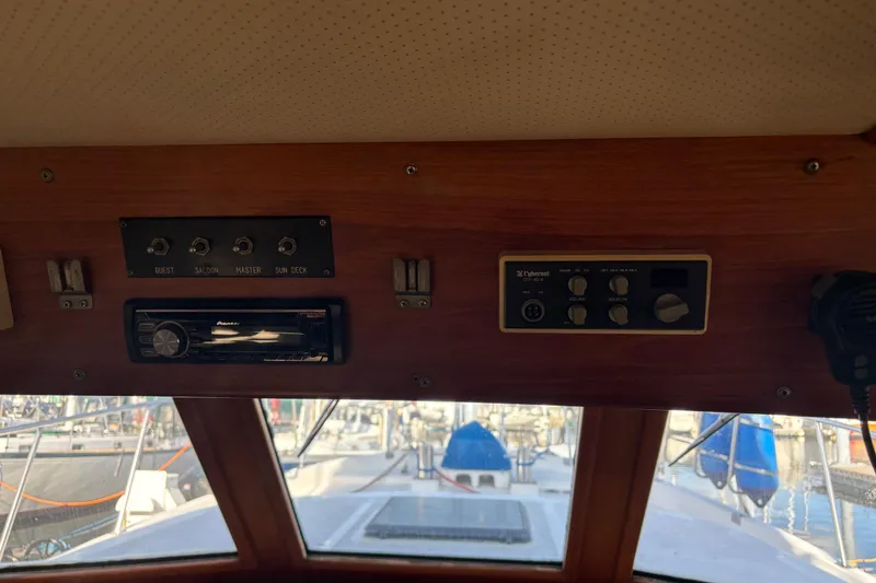 Slide: The Image of Interior view of a 1986 Ponderosa boat dashboard with control panels and stereo system. - 23