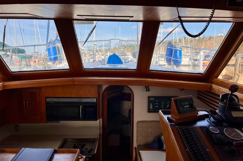 Slide: The Image of Interior view of 1986 CHB Ponderosa boat with marina in background. - 26