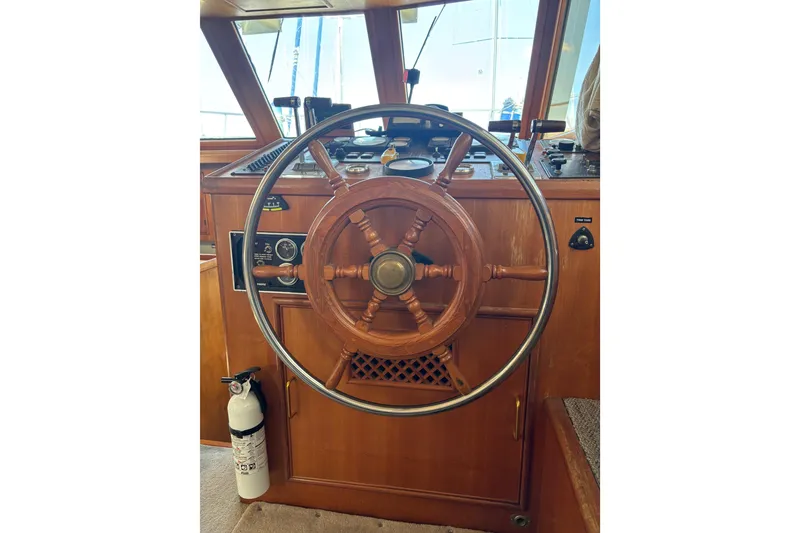 Slide: The Image of 1986 Ponderosa boat helm with wooden steering wheel and control panel. - 27