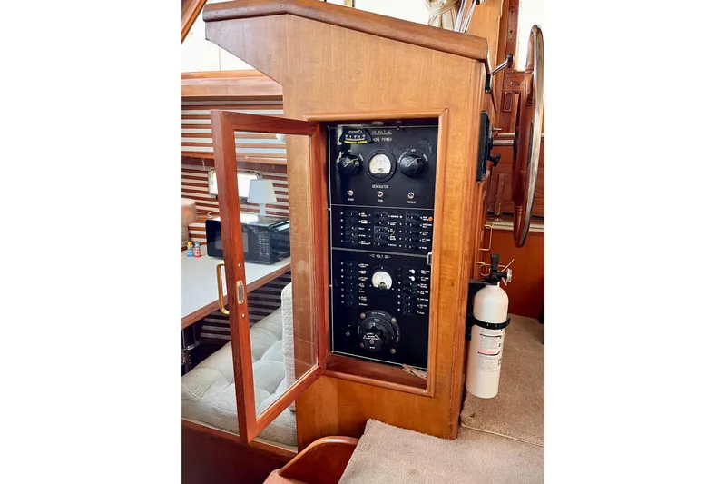 Slide: The Image of 1986 CHB Ponderosa yacht control panel with gauges and fire extinguisher. - 28