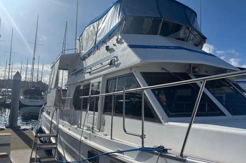 Slide: The Image of 1986 Ponderosa yacht docked at marina under clear blue sky. - 3