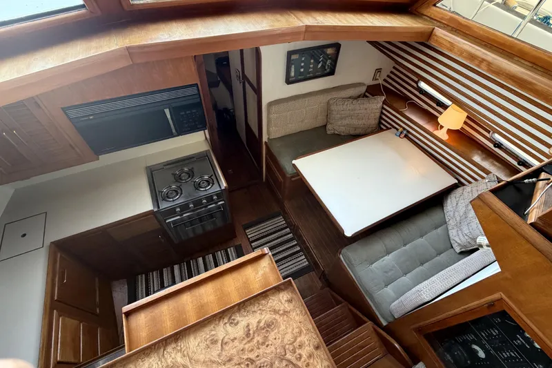 Slide: The Image of Interior of 1986 CHB Ponderosa yacht with kitchen and cozy dining area. - 30