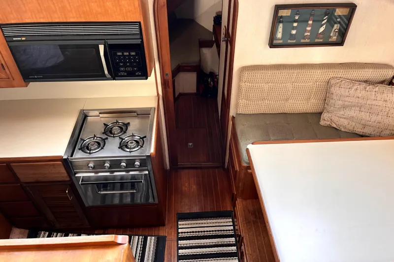 Slide: The Image of Interior of 1986 CHB Ponderosa boat with kitchen and seating area. - 31