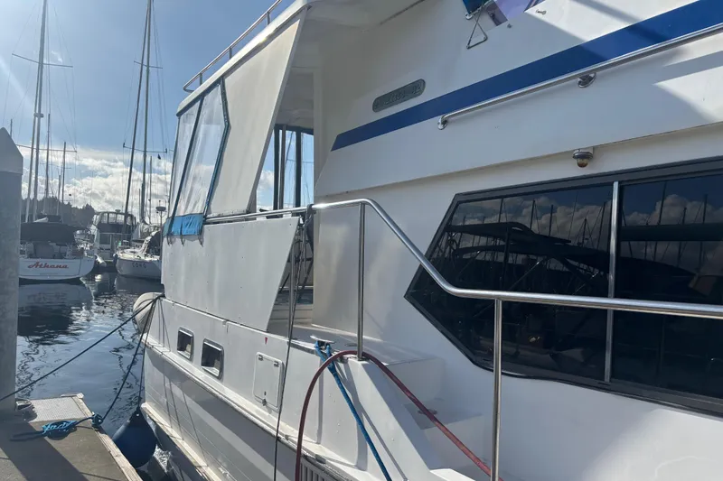 Slide: The Image of 1986 Ponderosa boat docked at marina under sunny sky. - 4