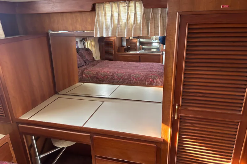 Slide: The Image of 1986 Ponderosa boat interior with wooden cabinetry and cozy bedroom. - 43