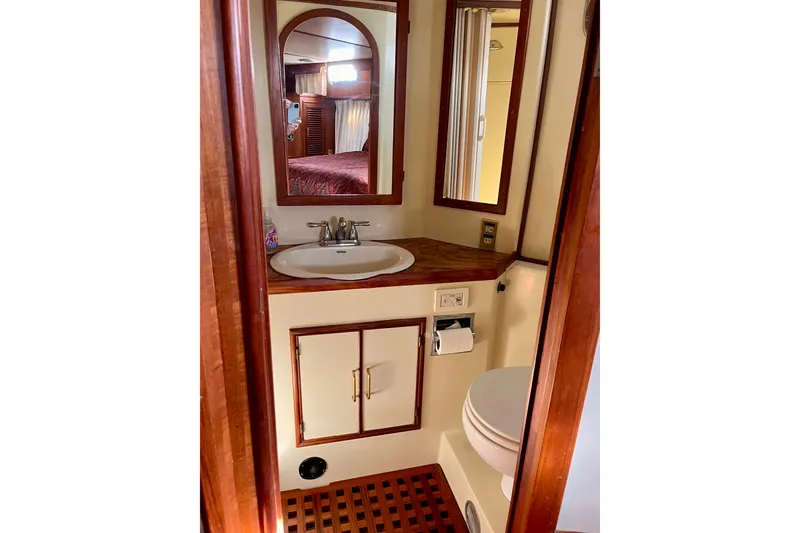 Slide: The Image of 1986 CHB Ponderosa yacht bathroom with sink, mirror, and wooden accents. - 44
