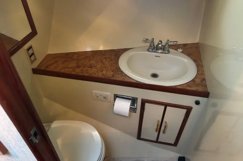 Slide: The Image of Compact 1986 Ponderosa bathroom with sink, toilet, and wood accents. - 45