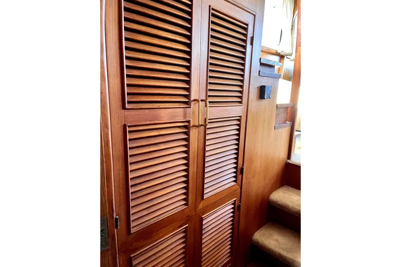 Slide: The Image of Wooden louvered door inside 1986 CHB Ponderosa boat, next to carpeted stairs. - 46