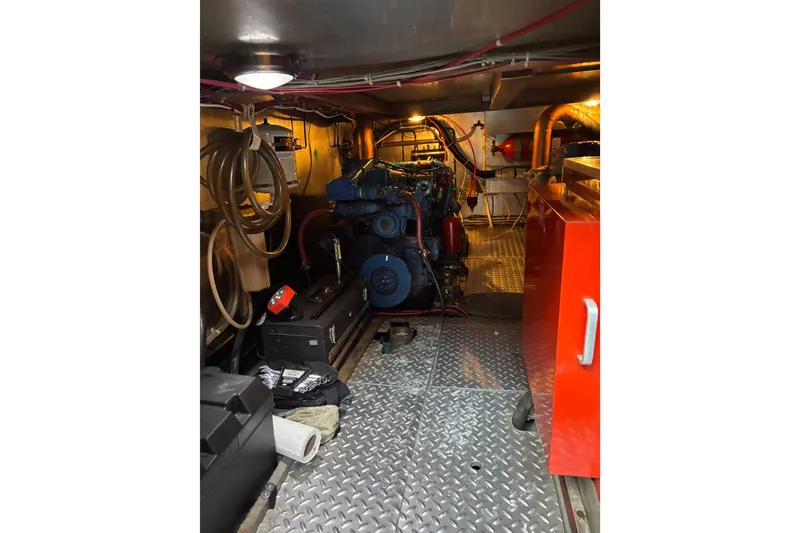 Slide: The Image of Engine room of a 1986 Ponderosa boat with visible machinery and equipment. - 51