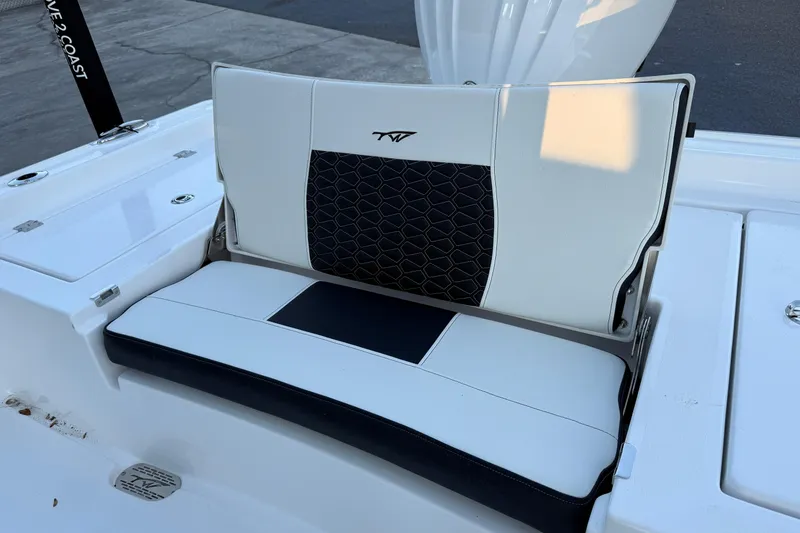 Slide: The Image of 2026 Tidewater 2300 Carolina Bay boat dashboard with steering wheel and navigation controls. - 10