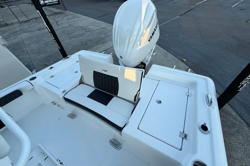 Slide: The Image of 2026 Tidewater 2300 Carolina Bay boat dashboard with steering wheel and navigation controls. - 11