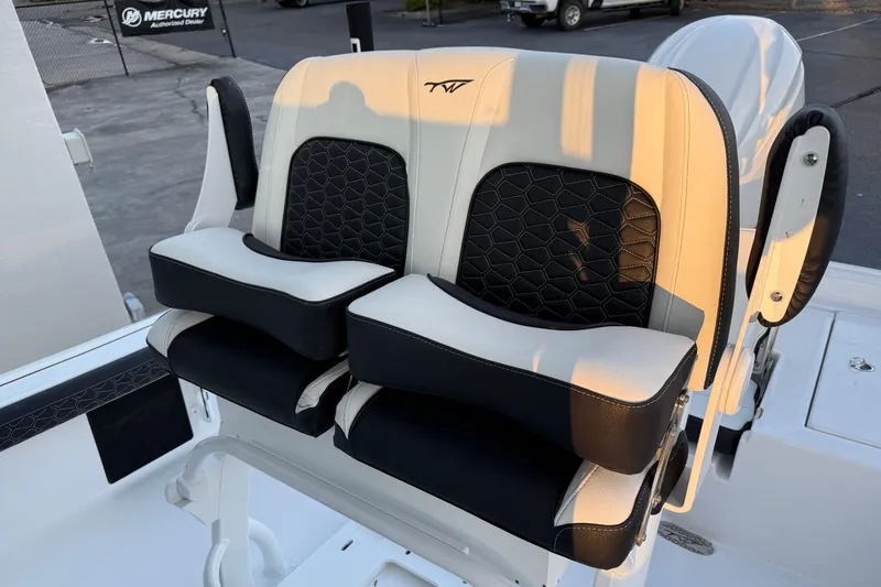 Slide: The Image of 2026 Tidewater 2300 Carolina Bay boat seat with black and white upholstery design. - 12
