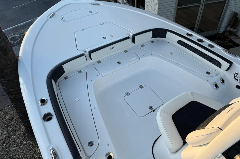 Slide: The Image of 2026 Tidewater 2300 Carolina Bay boat hatch with open lid and lock mechanism. - 17