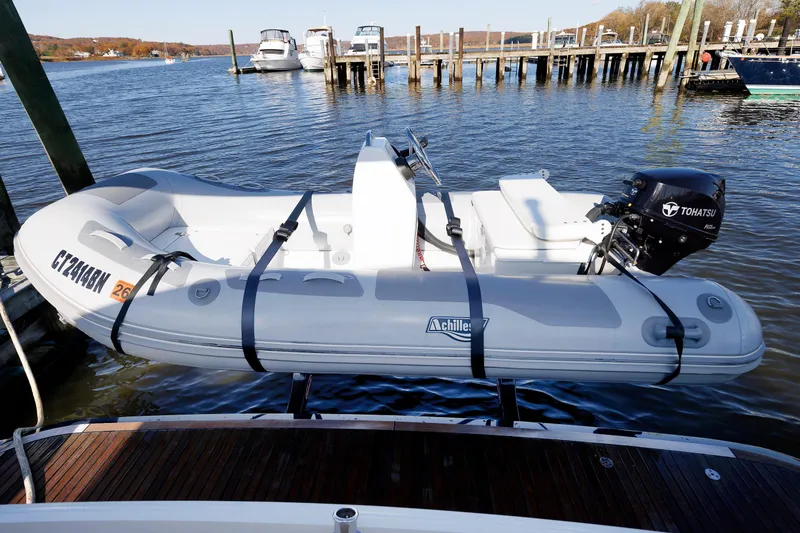 Slide: The Image of Inflatable boat with Tohatsu motor docked near Grand Banks 44 Eastbay SX, 2019 model. - 11