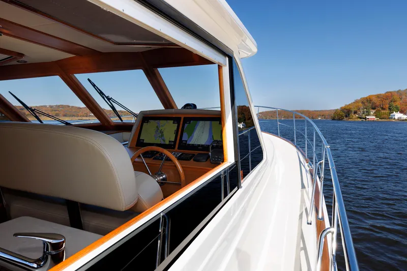 Slide: The Image of 2019 Grand Banks 44 Eastbay SX yacht cruising on a scenic lake. - 16