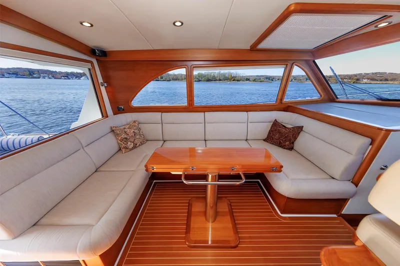 Slide: The Image of Luxurious interior of 2019 Grand Banks 44 Eastbay SX yacht with elegant seating and wooden table. - 29