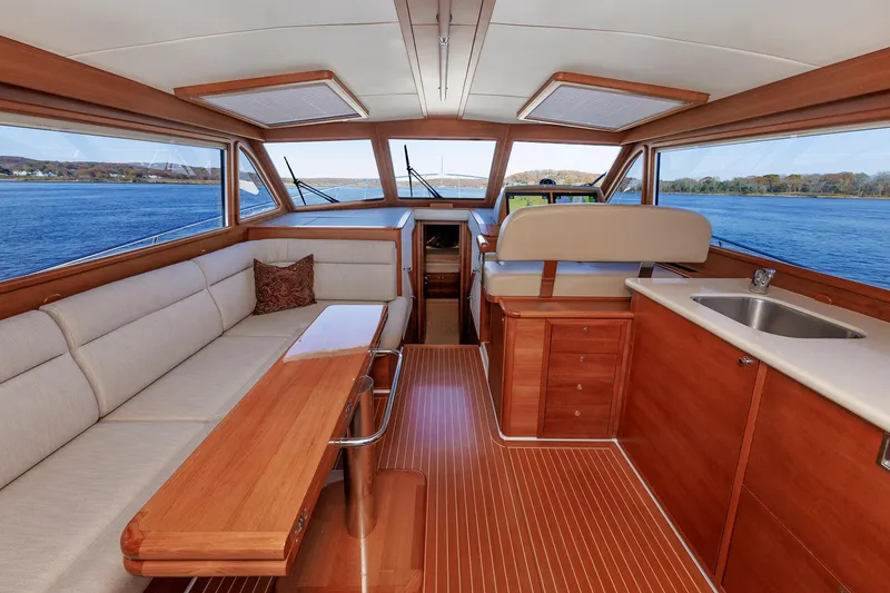 Slide: The Image of Luxurious interior of 2019 Grand Banks 44 Eastbay SX yacht with wood finish and scenic water view. - 31