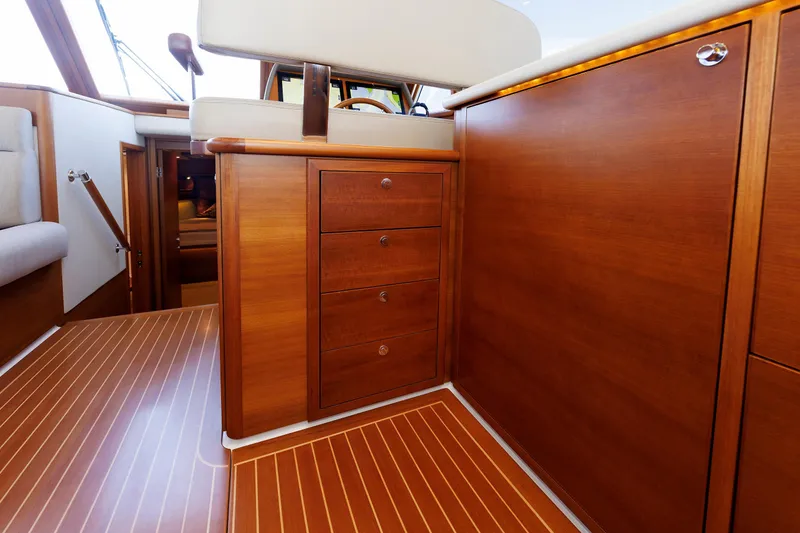 Slide: The Image of 2019 Grand Banks 44 Eastbay SX interior with elegant wood cabinetry and flooring. - 33