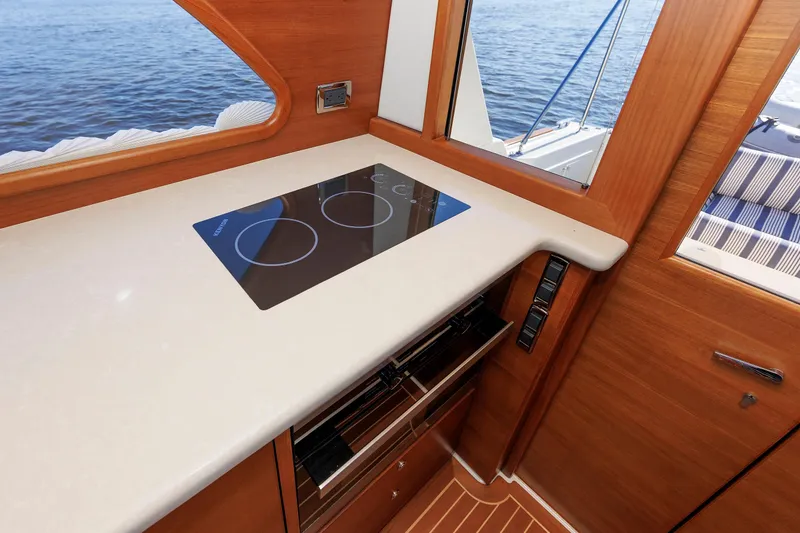 Slide: The Image of 2019 Grand Banks 44 Eastbay SX yacht interior with modern kitchen and sea view. - 35