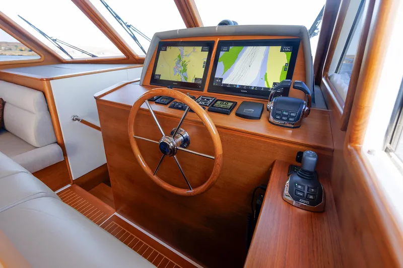 Slide: The Image of Helm of 2019 Grand Banks 44 Eastbay SX with navigation screens and controls. - 38
