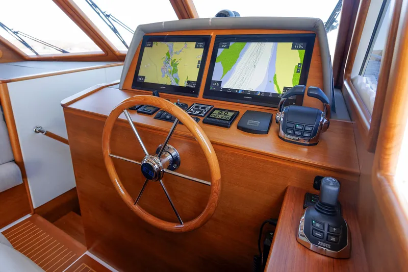 Slide: The Image of 2019 Grand Banks 44 Eastbay SX helm with navigation screens and wooden steering wheel. - 39